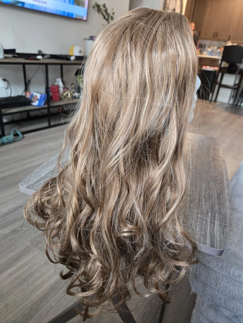 Women's long, wavy synthetic wig in a light brown/honey blonde Light Curls
